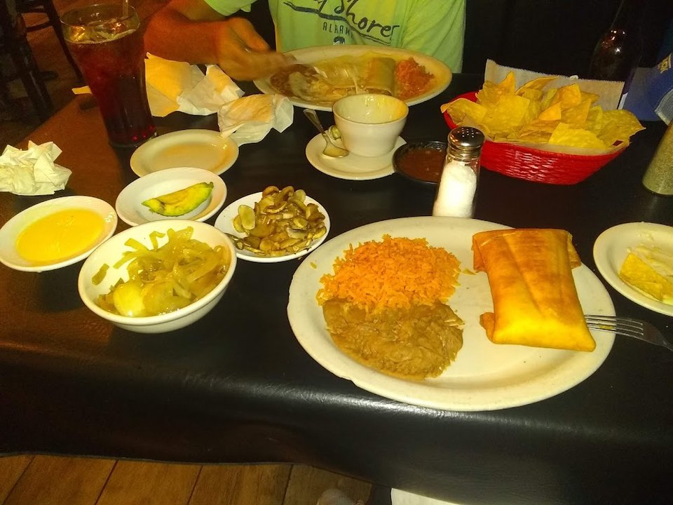 Menu-style spread of tacos and enchiladas.